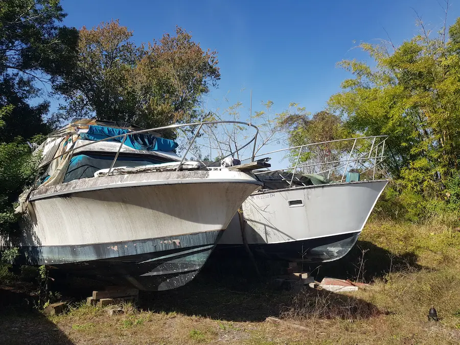A person using compressed air to clean a computer case, focusing on dust removal.